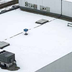 Top view of a generic looking flat and white commercial roof